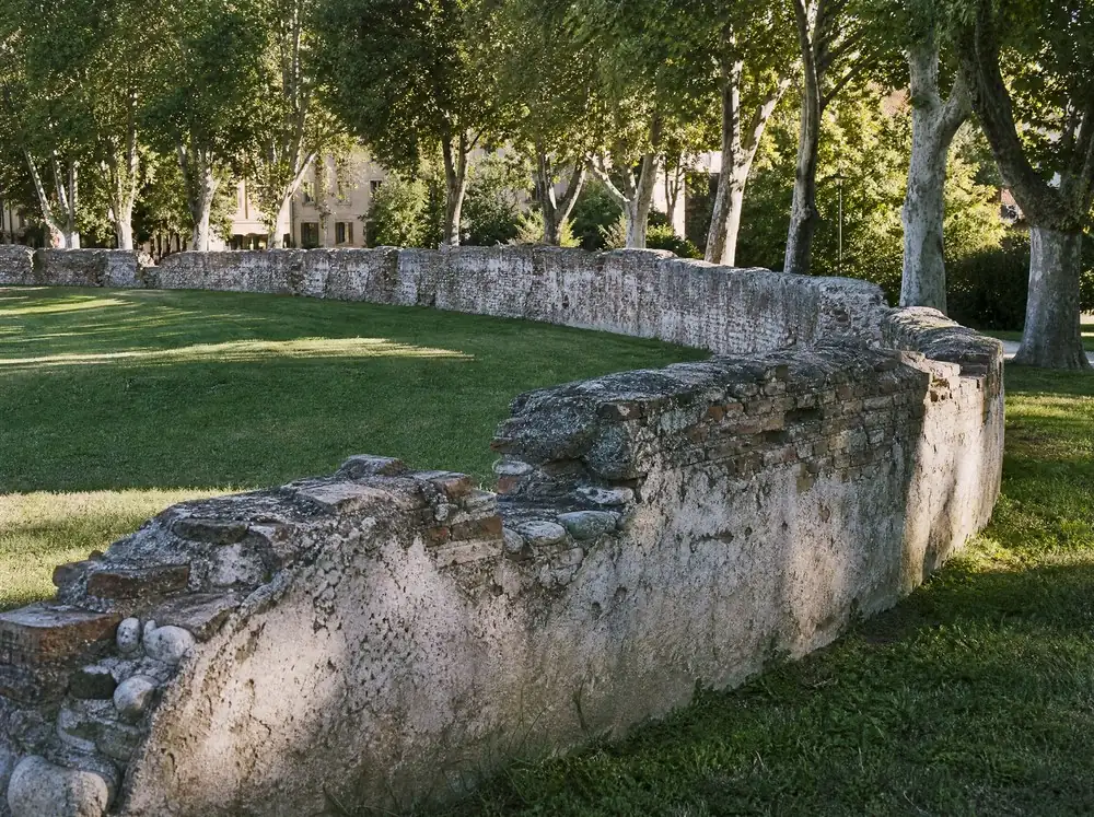 The curved remains of a Roman arena wall in a public garden