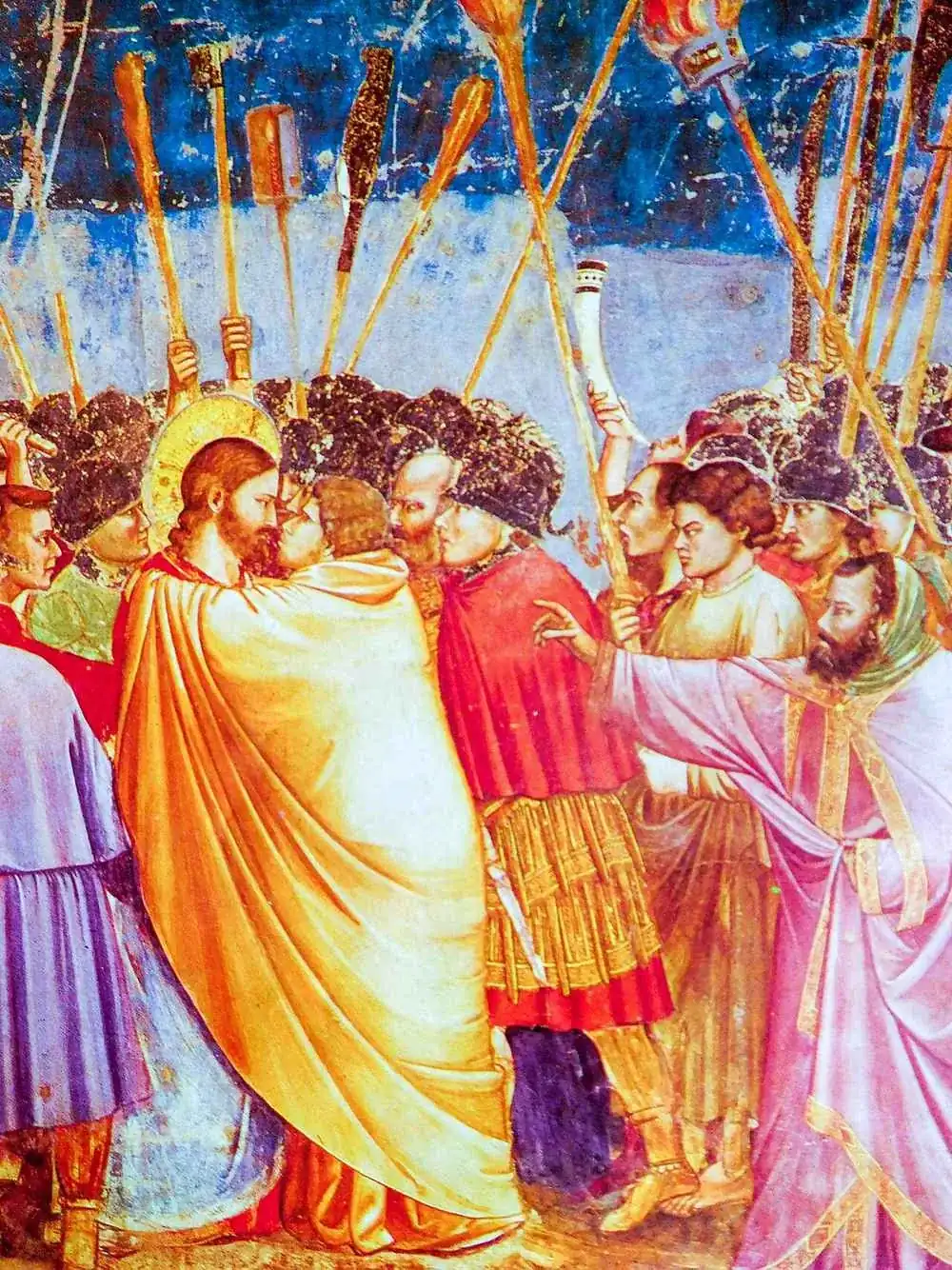 Il Bacio di Giuda: Giuda che avvolge il suo mantello intorno a Cristo, i loro volti quasi si toccano, bastoni e torce sullo sfondo
